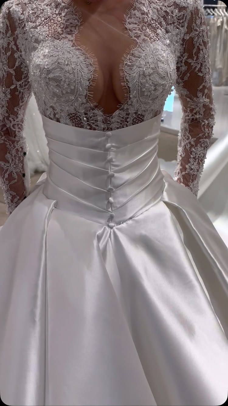 Classy Wedding Dress: 7 Styles That Photograph Beautifully 7 Ivory satin wedding dress with a lace bodice and long sleeves.