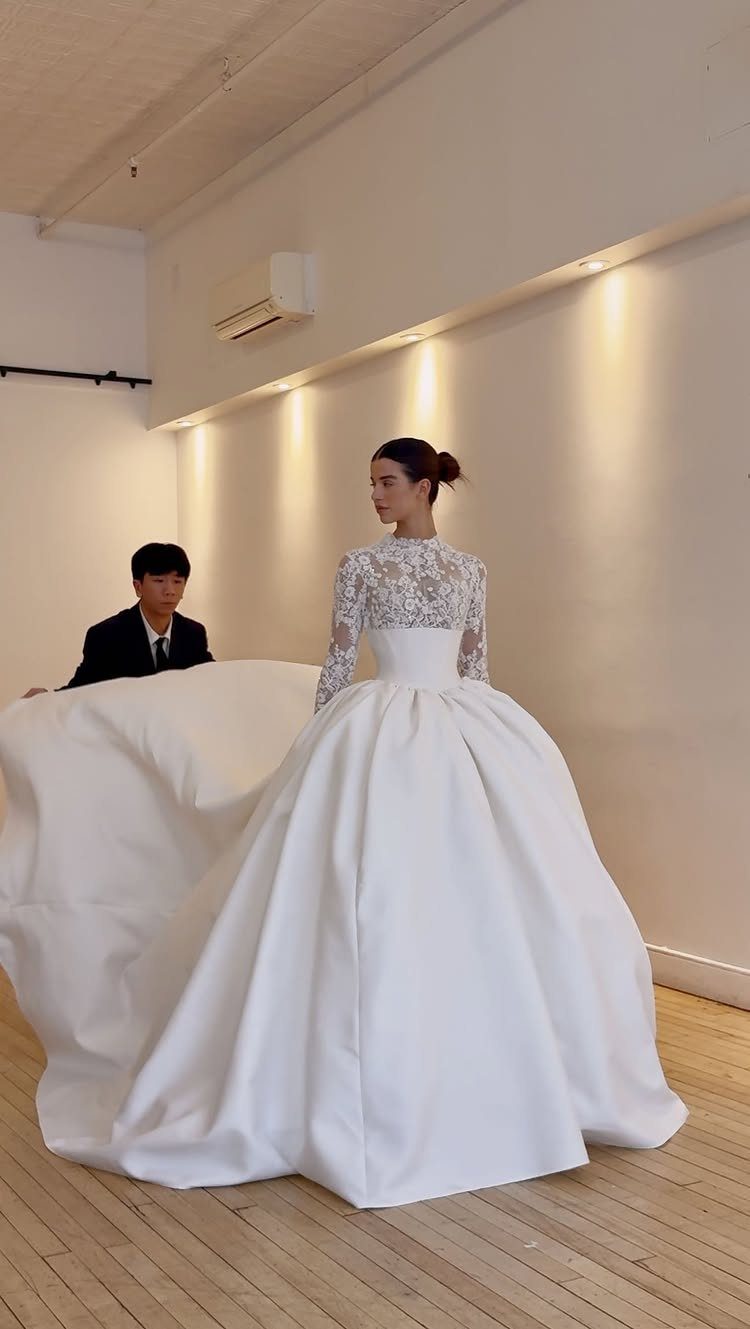 Classy Wedding Dress: 7 Styles That Photograph Beautifully 4 A woman wearing a white satin ballgown with a lace bodice and voluminous skirt.