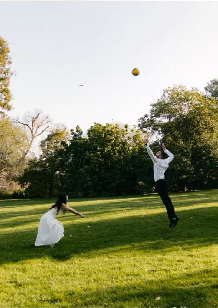 17 Couple Pictures for Your Wedding That Feel Real, Not Posed 16 A bride and groom playing with a yellow ball on a sunny green lawn.