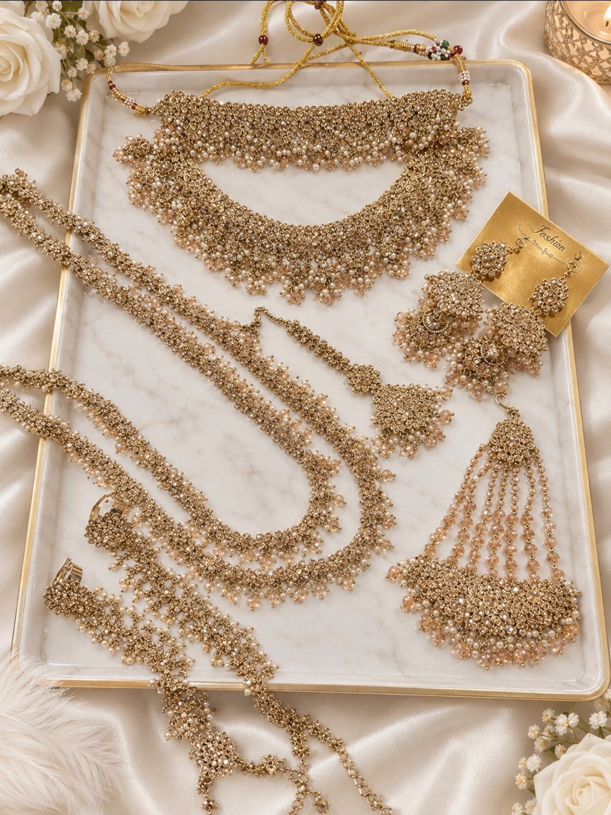 Crystal Jewelry Sets for 6 Style Moods 6 Gold-toned crystal jewelry set with necklaces, earrings, and headpiece on a marble tray.