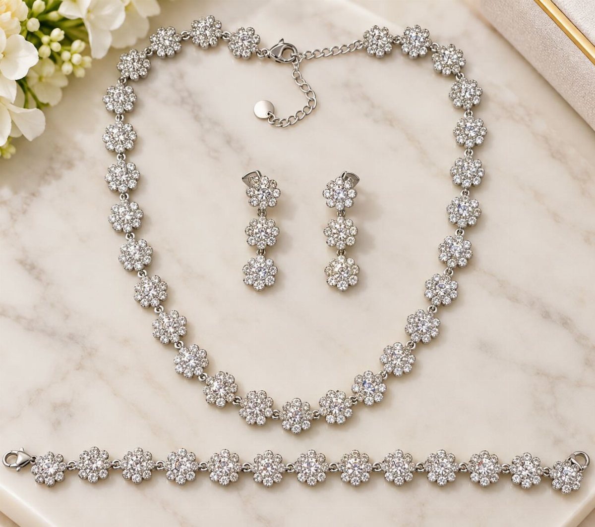 Crystal Jewelry Sets for 6 Style Moods 4 Silver jewelry set with clear crystal floral clusters on a marble background.