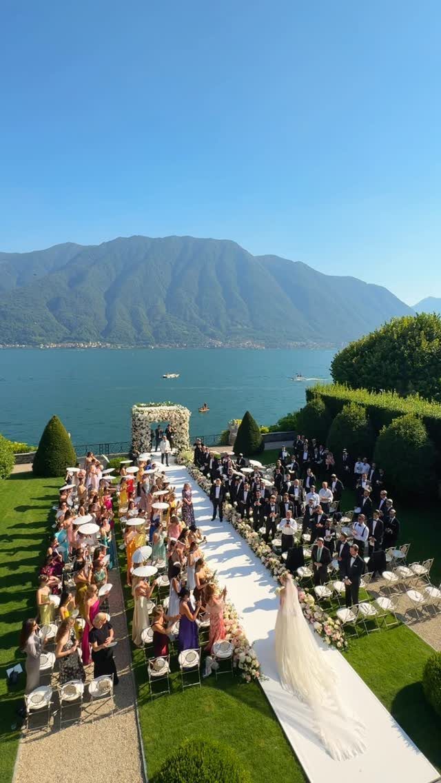 Garden Wedding Ceremony: 9 Ideas for Intimate Outdoor Vows 5 Wedding ceremony setup with a white aisle runner on a green lawn overlooking a lake and mountains.