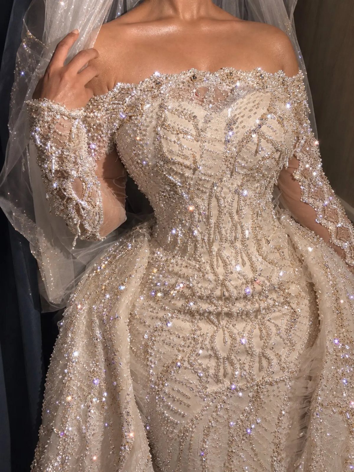 Gold and Champagne Wedding: 7 Ideas for a Warm, Metallic Celebration 3 Intricately beaded champagne-toned bridal gown with sparkling crystals and off-the-shoulder sleeves.