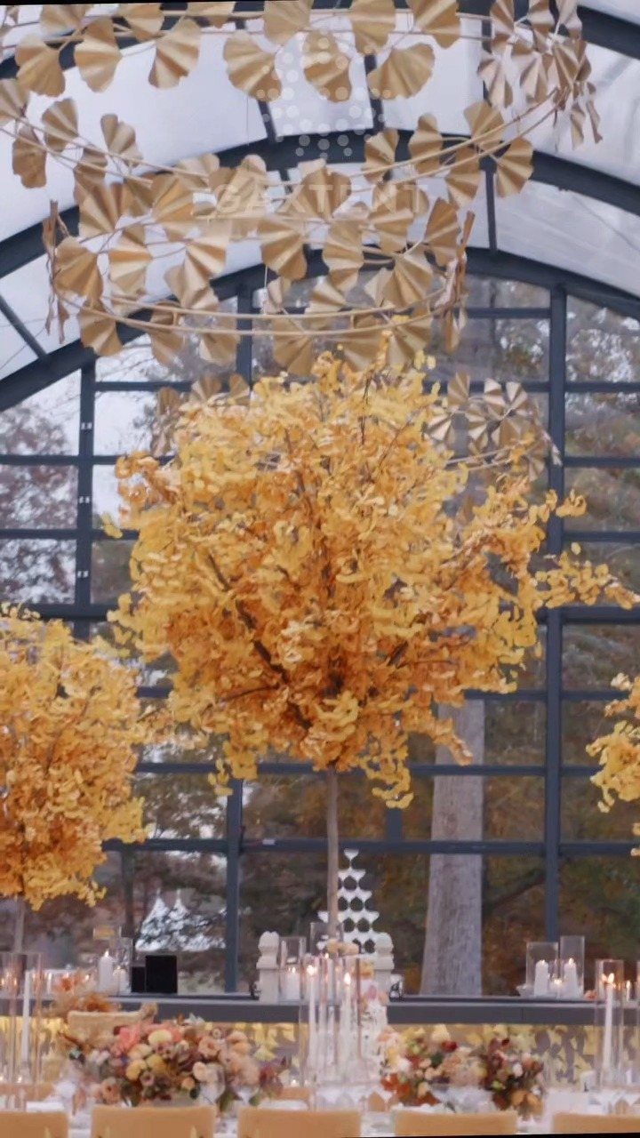 Gold and Champagne Wedding: 7 Ideas for a Warm, Metallic Celebration 1 Golden ginkgo leaf decorations and large golden tree centerpieces at a wedding reception.