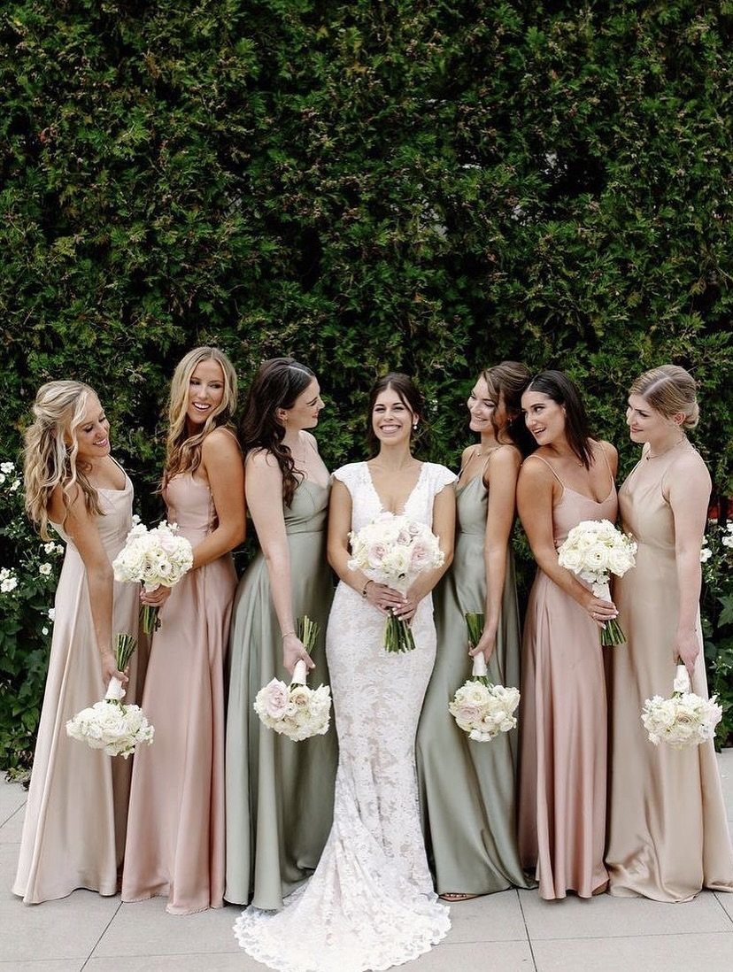 Green Wedding Colors: 8 Palettes From Olive to Emerald 6 Bridesmaids in sage green and dusty rose dresses holding white bouquets standing with a bride.