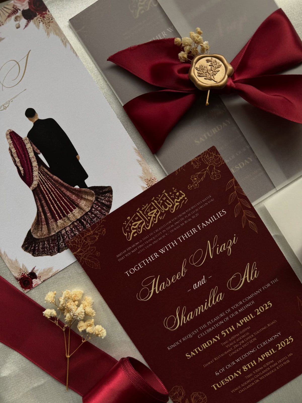 12 Ideas for a Red and White Wedding Theme 10 Burgundy wedding invitations with gold text, a red ribbon, and a wax seal on a light surface.