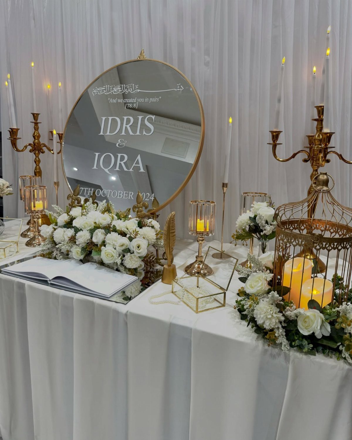 Wedding Decorations and Flowers: 8 Ideas for Ceremony to Reception 5 White floral arrangements and gold candle holders decorate a wedding welcome table with a mirror.